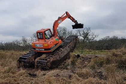 Amphibious digger used to attract wildlife to moor