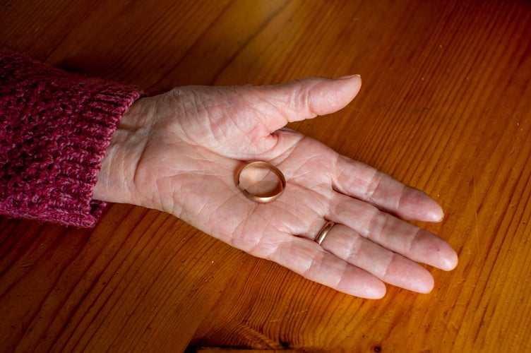 Ann Kendrick from Portlooe, Cornwall, holds her late husband's wedding ring. 27th April 2022  See SWNS story SWPLring. A 90-year-old has found her late husband's wedding ring under an apple tree - 35 years after he lost it in their garden. Ann Kenrick says Peter, who passed away 22 years ago, lost his band while working in their back garden in Looe, Cornwall, in 1987. The mother-of-seven discovered the ring on Saturday (23 April) when she was clearing around the base of an apple tree. She said she was "very excited" to find the ring and added that her husband would have been "as surprised as her".  