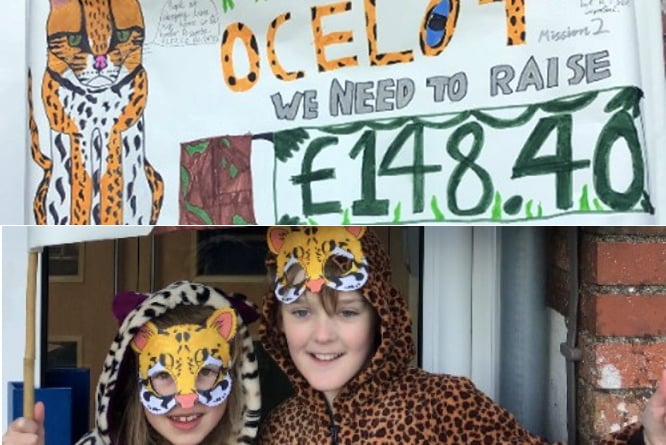 Two pupils in their fancy dress with a cleverly crafted handmade banner