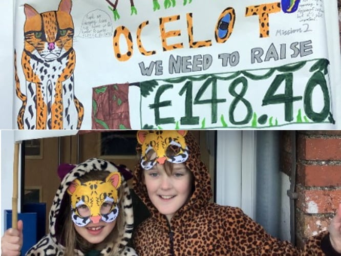 Two pupils in their fancy dress with a cleverly crafted handmade banner