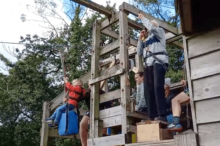 George Dawe, 92, and three-year-old Richard Oliver setting off on their zip-wire challenge on Monday