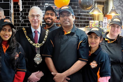 Mayor cuts ribbon during grand opening of pizzeria in Looe