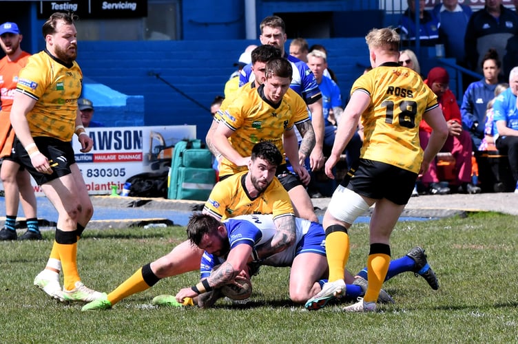 Cornwall's Jake Lloyd tackles Liam McNicholas.