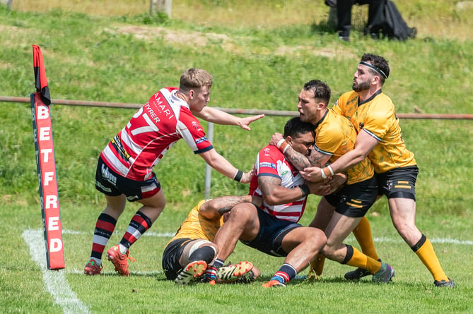 Cornwall's Coby Nichol stops Oldham captain Jordan Turner.