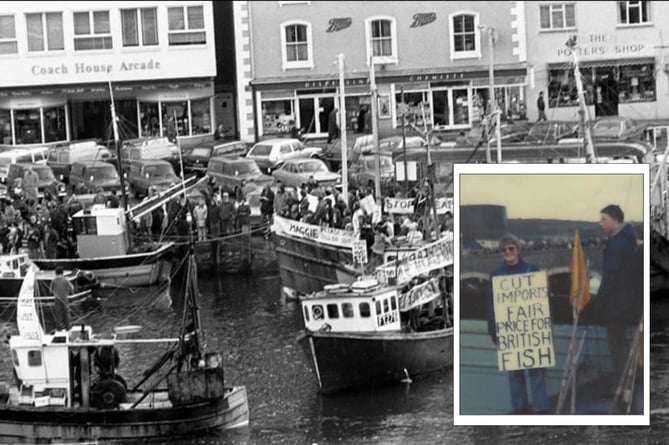 Sally Jaycock (inset) holds up a placard in support of Looe fishermen as skippers temporarily block Sir Chay Blyth’s trimaran leaving port