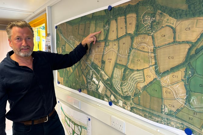 Project director Harry Lewis, of Treveth, with a map showing the various phases of development at Langarth Garden Village. (Picture: Lee Trewhela/LDRS)