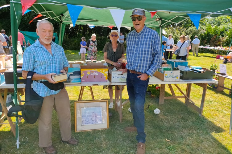 Rector of Lansallos, Rev Richard Allen and churchwarden Josie Slade on the book stall at Lansallos Fete