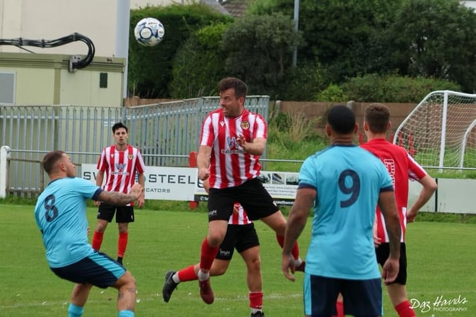 Saltash's man of the match Tom Payne goes up for a header. Picture: Daz Hands Photography