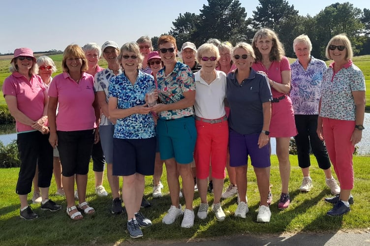 Players from both teams with the vice-captain Cathryn Braithwaite (left) and captain Sam Peach (right) holding the Captain v Vice Captain match trophy.