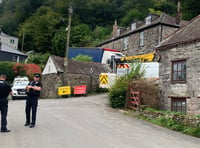 Work begins to free haulage truck stuck in narrow lane