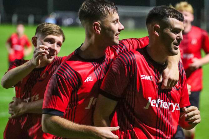 Dobwalls' players congratulate Adam Kenyon on his opener. Picture: Colin Hilton