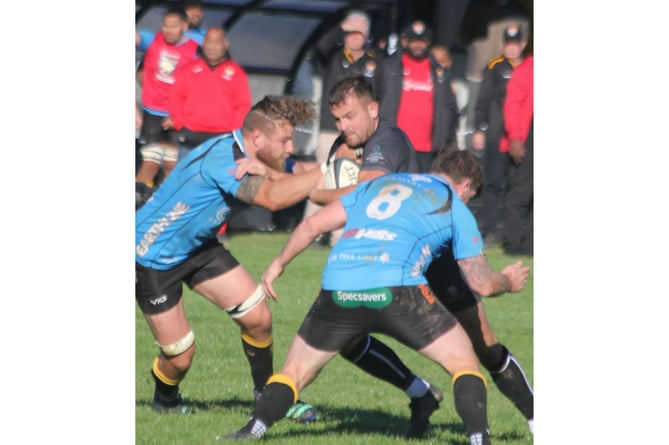 Two defenders aim to stop Launceston skipper Tom Sandercock in his tracks. Picture: Paul Hamlyn