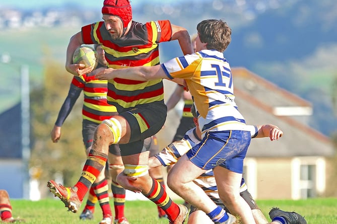 Lock Aidan Marshall powers through despite the best efforts of the Camborne School of Mines defence. Picture: Glen Rogers