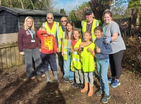 Rotary club helps to clean up land at school