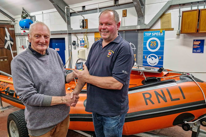 Dave Haines congratulating his successor Clive Palfrey and passing over the LOM pager and station keys. (Picture: 	RNLI / Ian Foster)