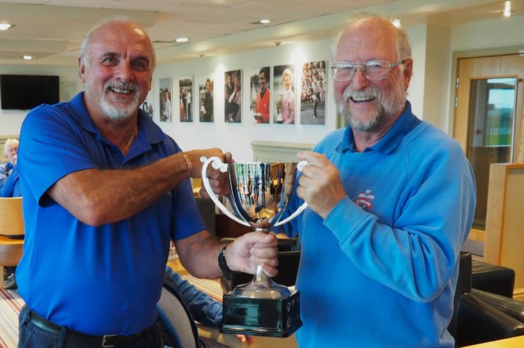 Fossils captain Chris de Beaufort (left) presents Ian Edwards with the Hi-Lo Trophy. Picture: St Mellion Golf Club