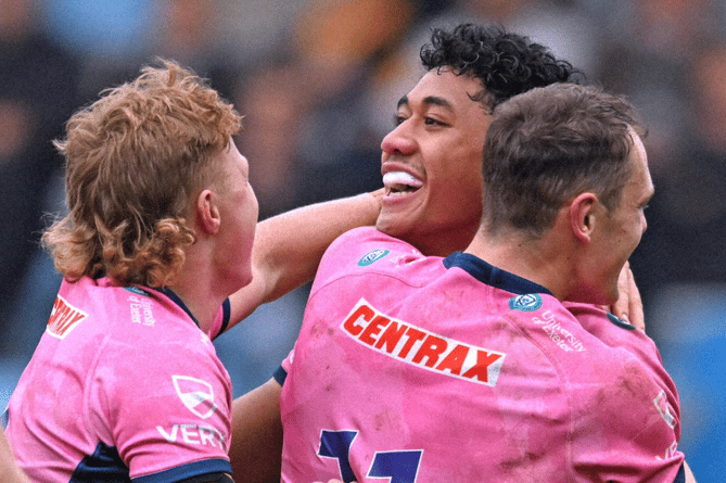 Exeter Chiefs try-scorer Greg Fisilau celebrates with team-mates Will Becconsall and Tom Wyatt