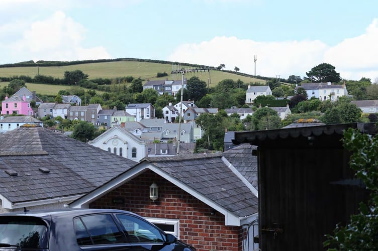 A PHOTO of the view across Millbrook toward Blindwell Hill, with the proposed mast superimposed onto the image. 
