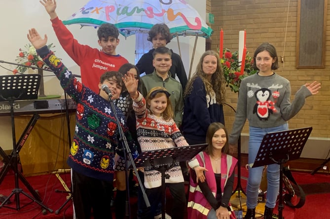 The cast from an upcoming production of Mary Poppins at Saltash Community School sang and brought along their giant Mary Poppins umbrella lantern. (Picture: Sarah Martin)