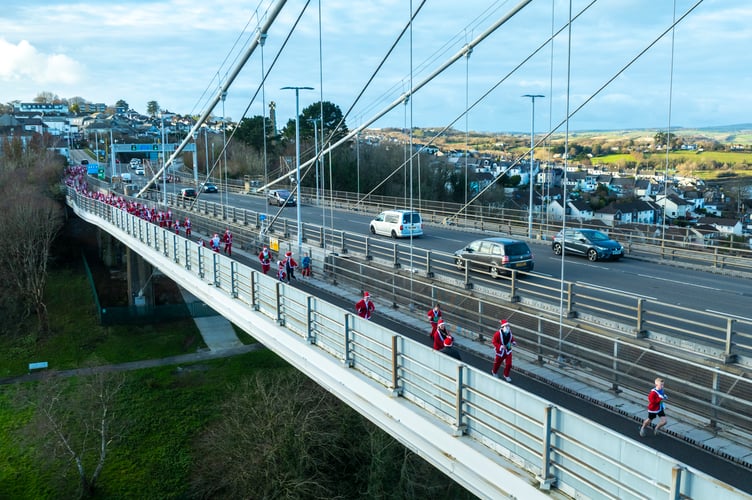 More than 220 Santas joined in with the Santa Fun Run across the Tamar Bridge to Devon and back up Saltash Fore Street. (Picture: Cornish Drone Photography)