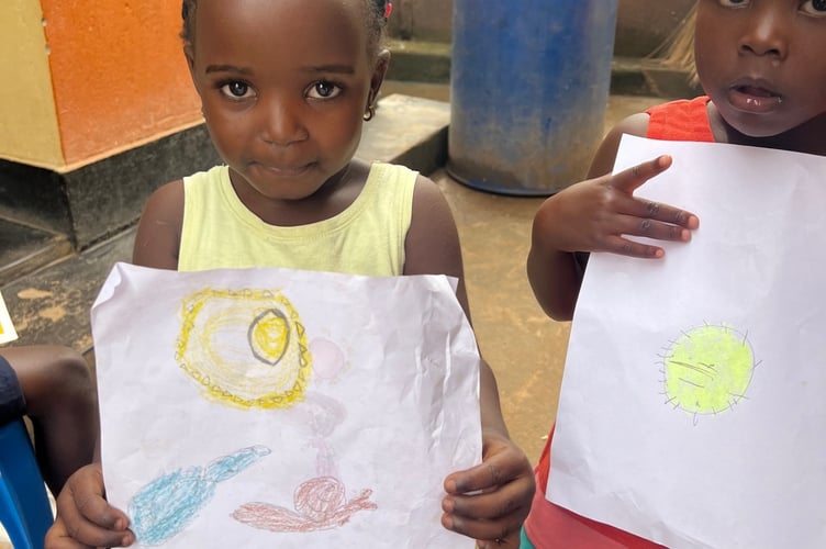 Children from Kigungu Kids Educare in Entebbe have taken a shine to Ella who is teaching them how to write letters and to pair them with the sounds they make. (Picture: Ella Carpenter)