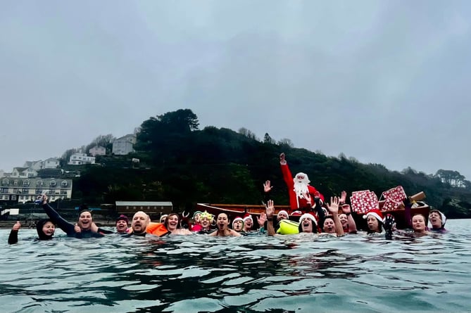 Cold water enthusiasts took to the sea at Looe on Christmas Eve and were joined by the big man himself. (Picture: Guy Cooper)