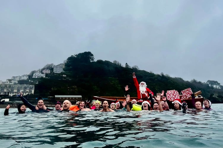 Cold water enthusiasts took to the sea at Looe on Christmas Eve and were joined by the big man himself. (Picture: Guy Cooper)