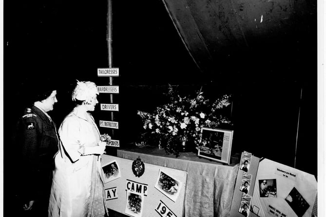 Her Majesty, Queen Elizabeth the Queen Mother enjoying the floral arrangements 