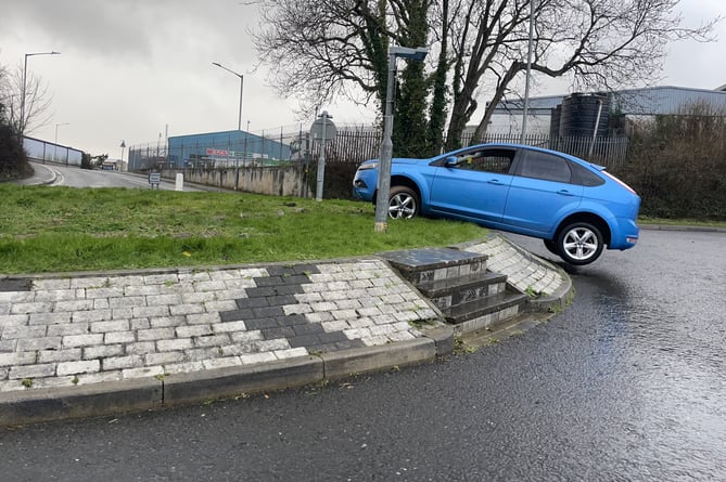 A car has somehow managed to ridge itself on Pilmere roundabout in Saltash